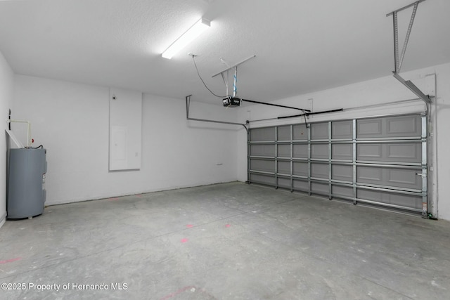 garage with a garage door opener and electric water heater