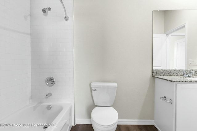 full bath with shower / bathtub combination, toilet, vanity, wood finished floors, and baseboards