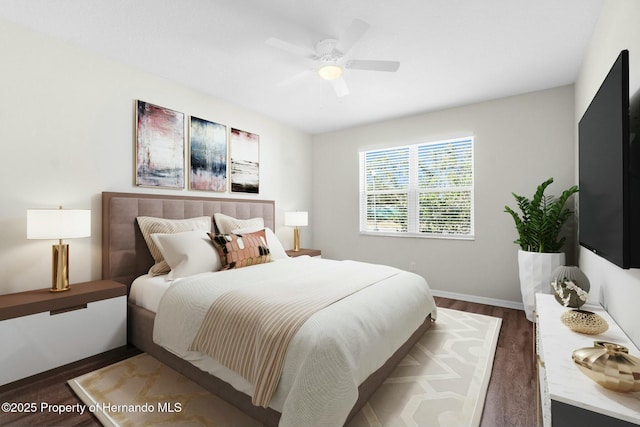 bedroom featuring dark wood-type flooring, a ceiling fan, and baseboards