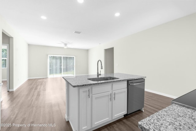 kitchen with a sink, white cabinetry, open floor plan, dishwasher, and an island with sink