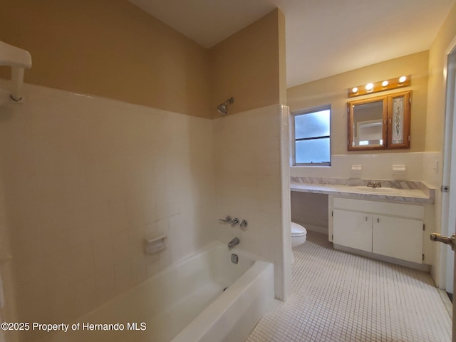 full bath featuring tile patterned flooring, toilet, vanity, tile walls, and  shower combination