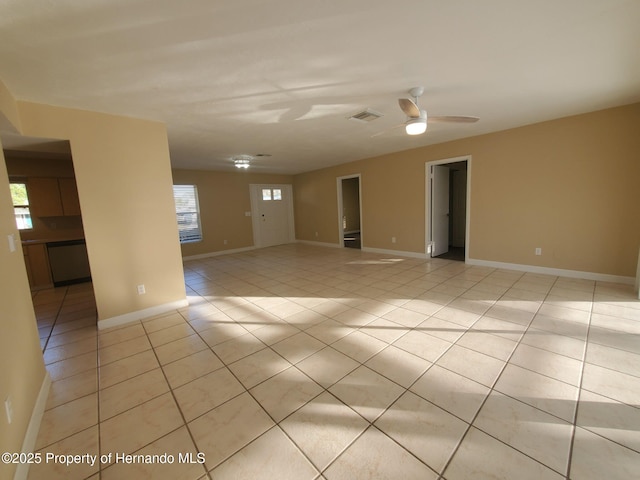 empty room featuring light tile patterned floors, baseboards, and visible vents