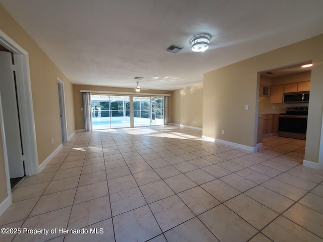 empty room featuring visible vents, baseboards, and light tile patterned flooring