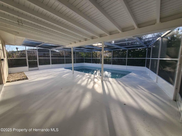 view of swimming pool with a fenced in pool, glass enclosure, and a patio