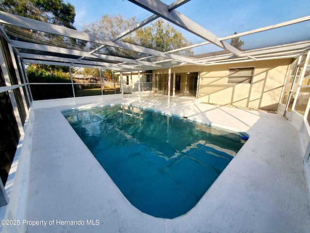 pool featuring a lanai and a patio