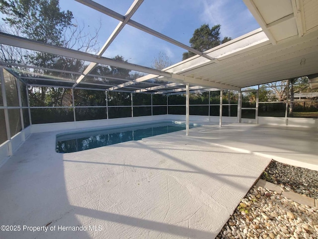 outdoor pool with a lanai and a patio area