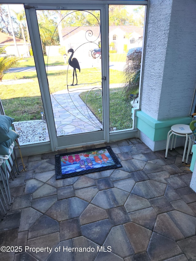 doorway featuring stone finish floor