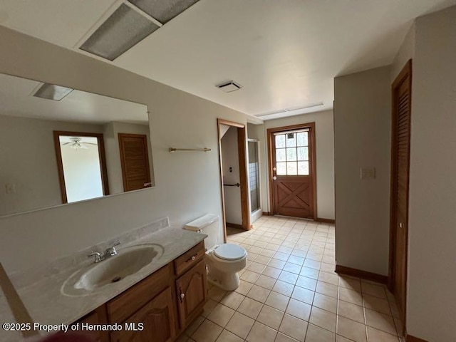 full bathroom featuring a closet, vanity, toilet, and tile patterned floors