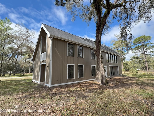 rear view of property with a yard