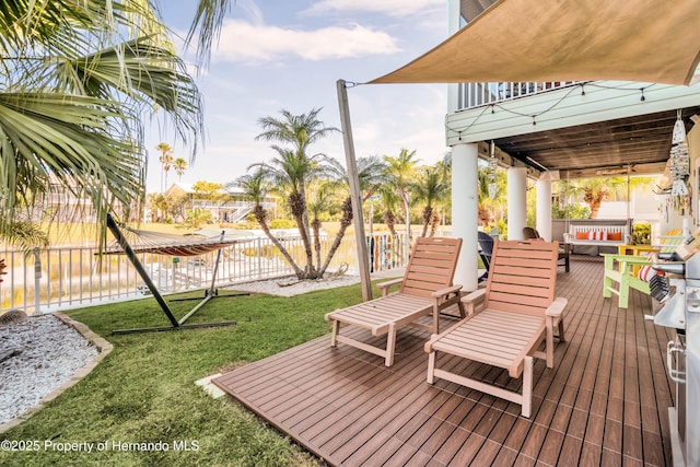 wooden terrace featuring fence, an outdoor hangout area, and a lawn