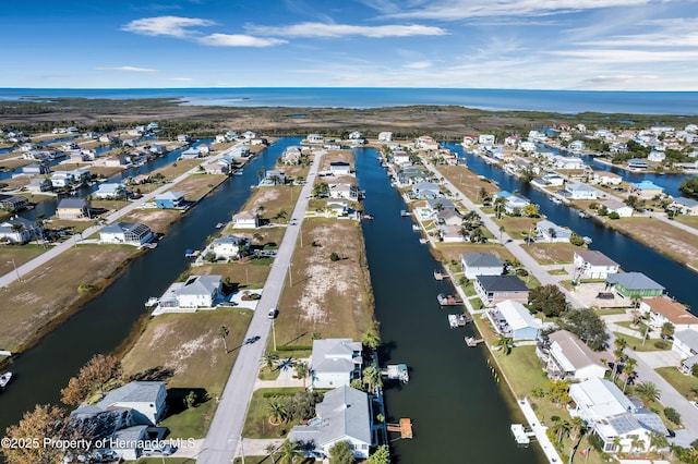 birds eye view of property featuring a water view and a residential view