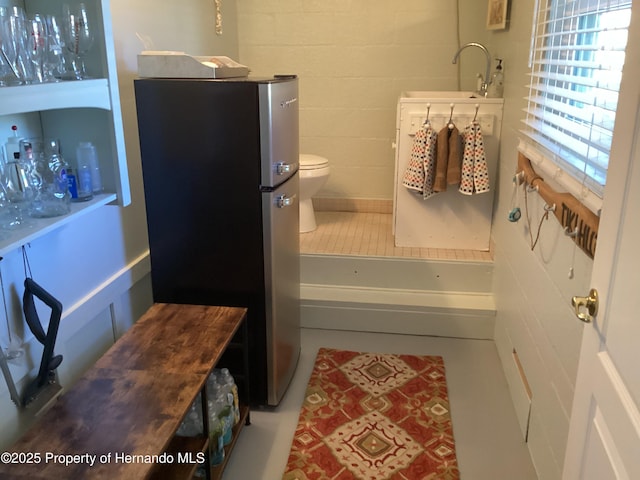 bathroom with tile patterned flooring, a sink, and toilet