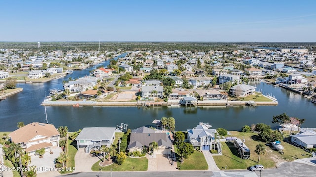 drone / aerial view with a water view and a residential view