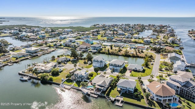 birds eye view of property with a water view and a residential view