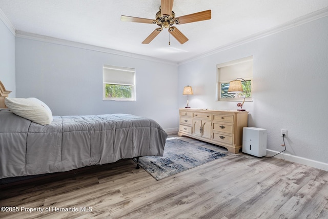 bedroom featuring baseboards, ornamental molding, and light wood-style floors