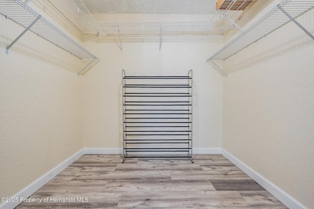 spacious closet with wood finished floors