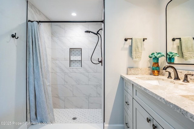 full bathroom with a shower stall and vanity