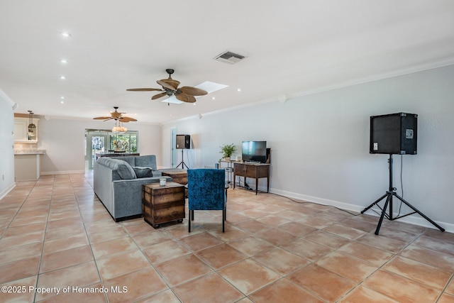 living area featuring light tile patterned floors, baseboards, visible vents, and crown molding