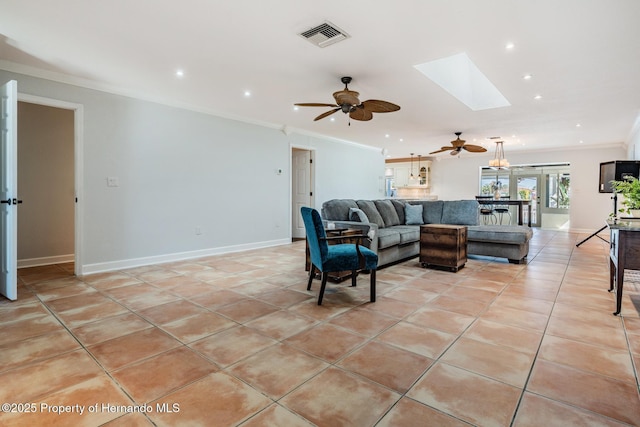 living area with light tile patterned floors, a skylight, visible vents, baseboards, and ornamental molding