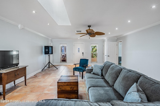 living area with a skylight, crown molding, light tile patterned floors, visible vents, and baseboards