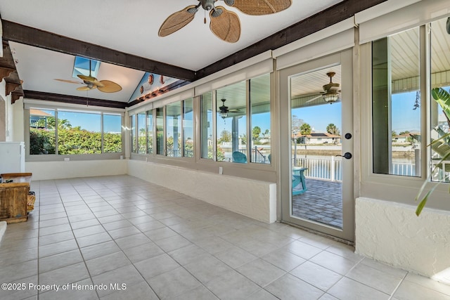 unfurnished sunroom with a water view, vaulted ceiling with beams, and ceiling fan