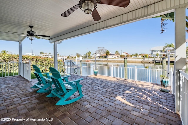 view of patio / terrace with a water view and a ceiling fan