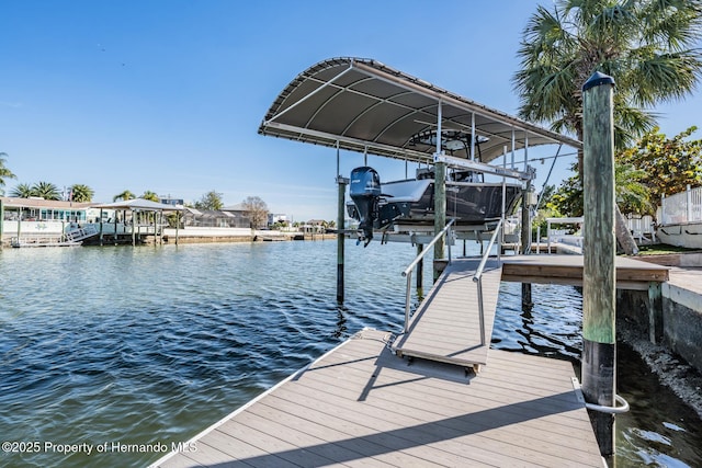 dock area with a water view and boat lift