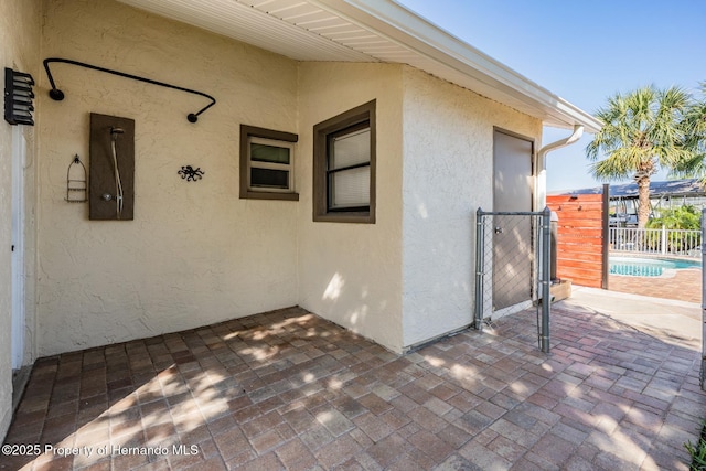 view of patio featuring fence and a gate