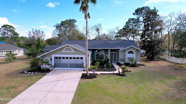 ranch-style home with driveway, a front lawn, and stucco siding