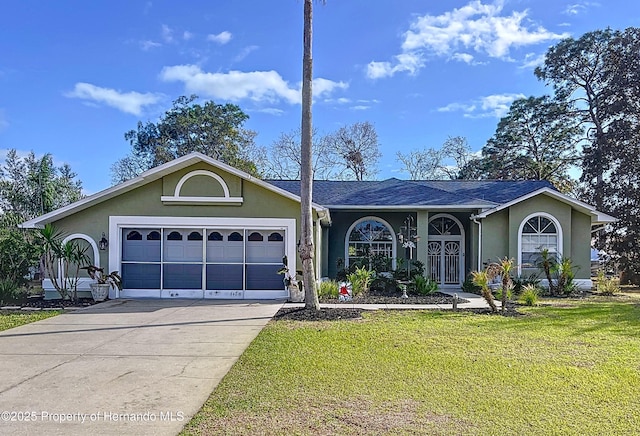 ranch-style house featuring an attached garage, driveway, a front lawn, and stucco siding