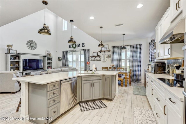 kitchen featuring visible vents, wood finish floors, dishwasher, black electric cooktop, and a sink