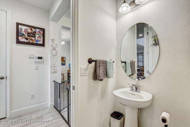 bathroom featuring baseboards and wood tiled floor