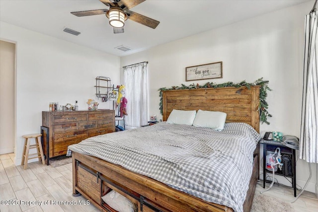 bedroom with visible vents, light wood-style flooring, and a ceiling fan