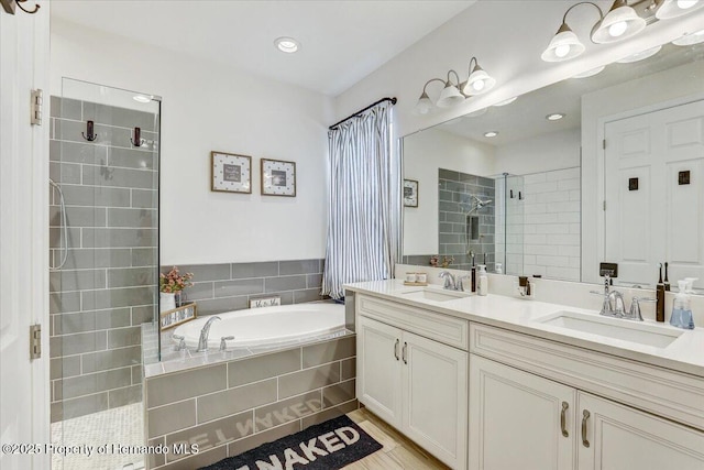 full bath with a sink, a garden tub, double vanity, and a shower stall