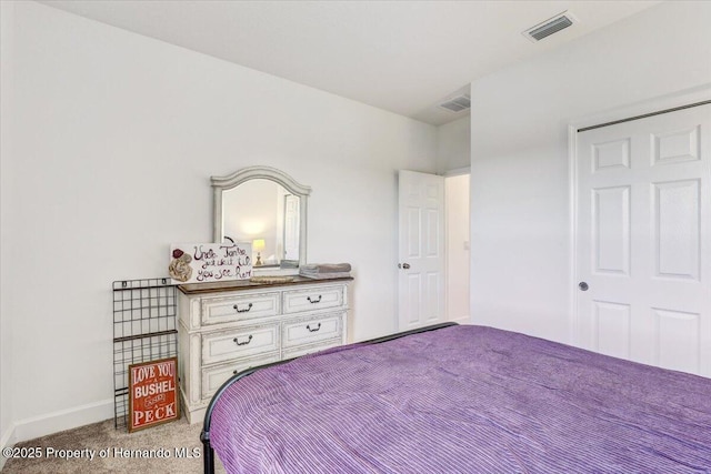 carpeted bedroom featuring baseboards and visible vents