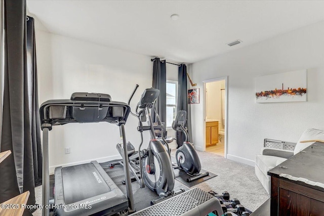 workout room featuring baseboards, visible vents, and carpet floors