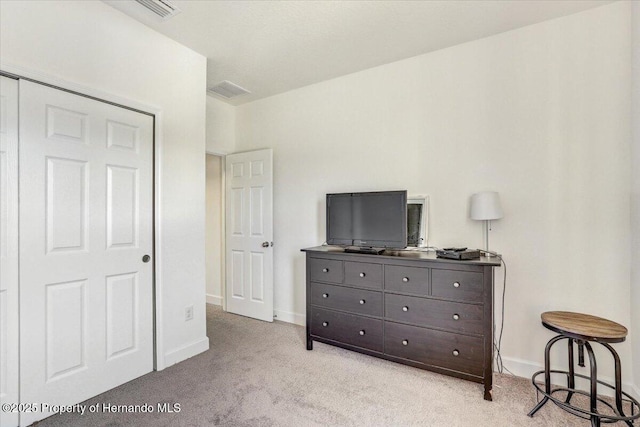 bedroom featuring visible vents, baseboards, and light colored carpet