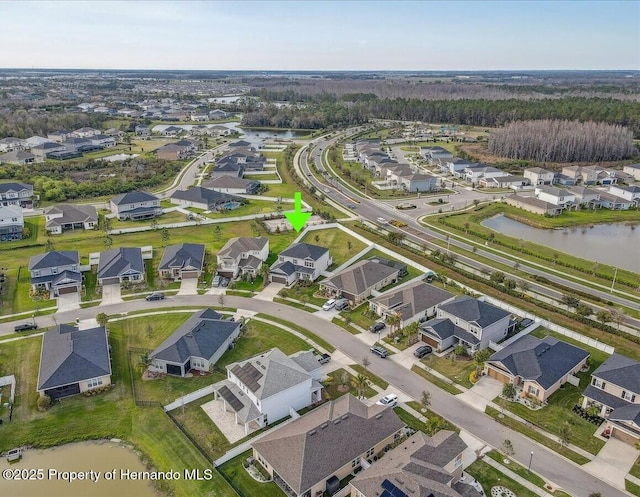 drone / aerial view featuring a residential view and a water view