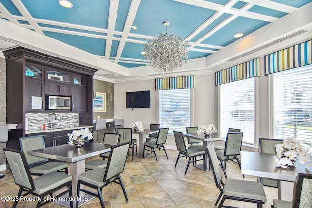 dining space featuring a notable chandelier, beam ceiling, coffered ceiling, and crown molding