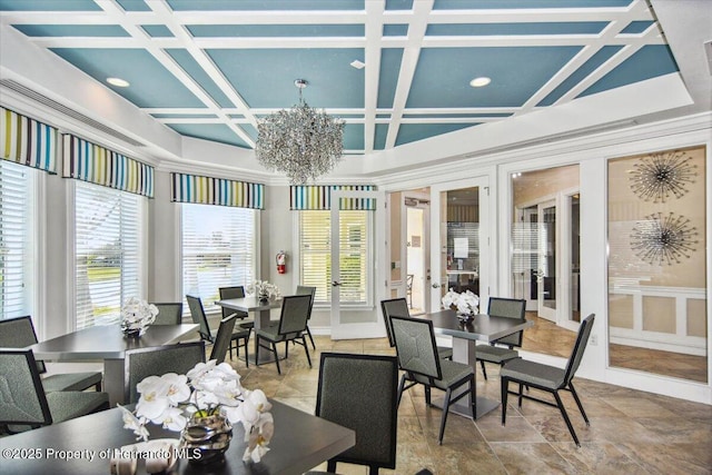 sunroom / solarium with french doors, coffered ceiling, a wealth of natural light, and a chandelier