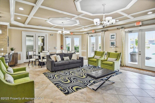 living room with plenty of natural light, french doors, coffered ceiling, and a chandelier