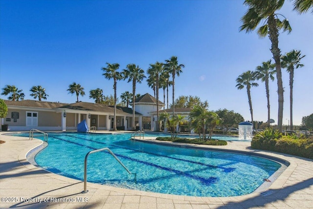 community pool with a patio area