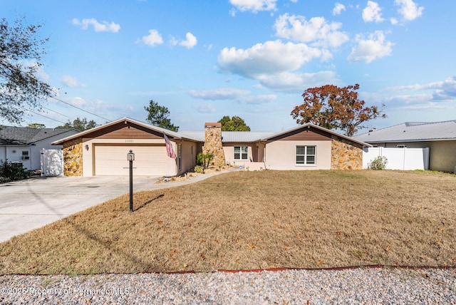 ranch-style home with a garage, concrete driveway, stone siding, a front lawn, and stucco siding