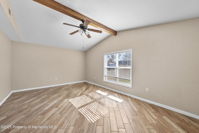 spare room featuring baseboards, light wood-style flooring, and lofted ceiling with beams