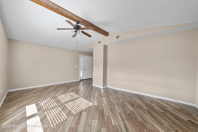 unfurnished room featuring vaulted ceiling with beams, visible vents, ceiling fan, light wood-type flooring, and baseboards