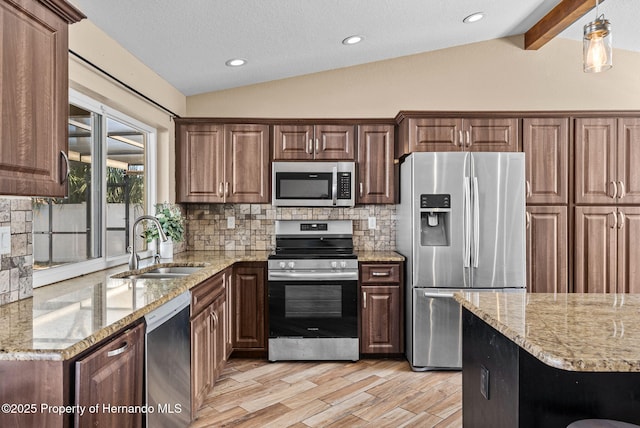 kitchen with stainless steel appliances, a sink, lofted ceiling with beams, and light stone countertops