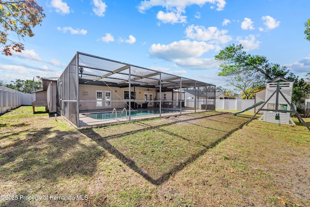 view of yard with a fenced backyard, a lanai, and a fenced in pool