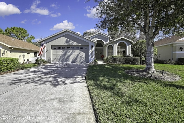 ranch-style home featuring a garage, concrete driveway, a front lawn, and stucco siding