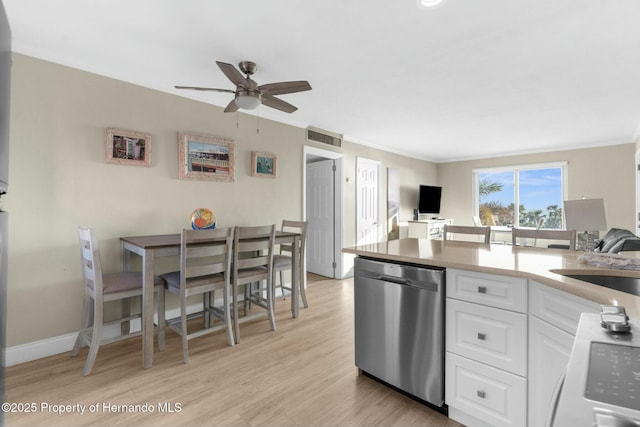 kitchen with stainless steel dishwasher, light wood-style floors, ornamental molding, open floor plan, and white cabinetry