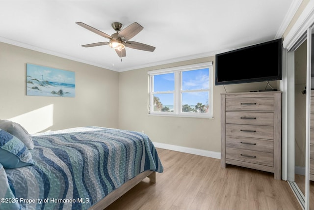 bedroom featuring ceiling fan, ornamental molding, wood finished floors, and baseboards